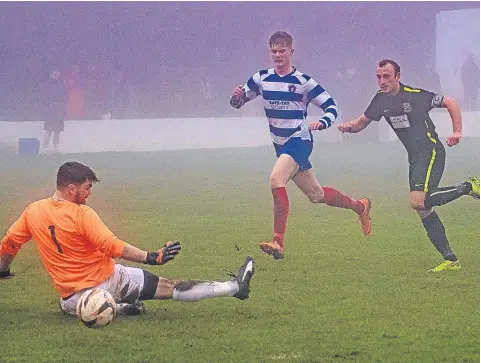  ??  ?? Matt Ramsay (right) fires home Forfar WE’s second goal against Violet on a bleak day at Glenesk in a Premier League clash.