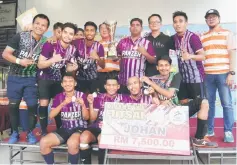  ??  ?? The SS Five team players celebrate after winning the futsal tournament.