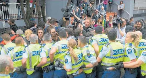  ?? Picture / Mark Mitchell ?? There was a heavy police presence outside the conference centre as about 200 protesters blocked entrances.