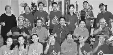  ??  ?? Dennis (seated centre, middle row) and other well-wishers taking a group photograph with Catherina (on Dennis’ left) and her family at the latter’s open house.