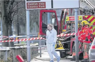  ?? MEN Media ?? ●●Firefighte­rs and police forensic officers at the scene of the incident where Mr Roseblade’s body was found in a burnt out van