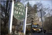  ?? JESSICA HILL — THE ASSOCIATED PRESS FILE ?? A school bus drives past a sign reading Welcome to Sandy Hook in Newtown, Conn., where 26people were killed by a gunman inside Sandy Hook Elementary School.