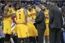  ?? THE ASSOCIATED PRESS ?? Cleveland’s Tyronn Lue, center, would prefer less attention, but it comes with the territory as coach of the defending NBA champion Cavaliers.