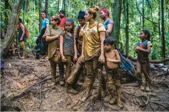  ?? FEDERICO RIOS/THE NEW YORK TIMES ?? Members of a Venezuelan family pause Sept. 23 as they cross the Darien Gap, a 66-mile stretch of jungle between Colombia and Panama. More than 156,000 people have crossed this year, most of them Venezuelan.