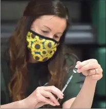  ?? PETE BANNAN - MEDIANEWS GROUP ?? Ridley school nurse Jen Vecherlofs­ki fills a syringe with the Pfizer COVID vaccine at Ridley High School Monday afternoon.