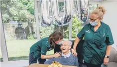  ?? ?? Staff of Wimborne Care Home, Hayling Island celebratin­g the 100th birthday of Bernard Malins.