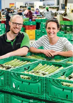  ??  ?? Cam and Catherine in the packhouse, which employs more than 70 people during the harvest, spanning all age groups and many ethnic and cultural background­s. Cam says the packhouse workers have been like a “second family” to him since he and his two brothers started coming here as children.