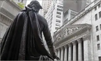  ?? RICHARD DREW/ AP FILE ?? The statue of George Washington on the steps of Federal Hall facing the facade of the New York Stock Exchange stands less than a mile from St. Paul’s Chapel, where the nation’s first president gave his first official Thanksgivi­ng address in 1789, a plea for unity and humbleness before God.