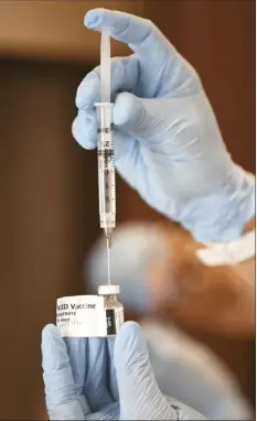  ??  ?? A dose of the Moderna vaccine is prepared during a drive-thru clinic for first responders and frontline workers at UH-Maui College on Wednesday. About 215 doses were administer­ed Wednesday, 470 Saturday and 562 Monday, according to a Maui District Health official.