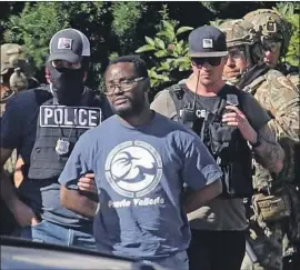  ?? Kristin Murphy Associated Press ?? SALT LAKE CITY police take Ayoola Ajayi into custody last month. He is accused of killing Mackenzie Lueck, a University of Utah student from El Segundo.