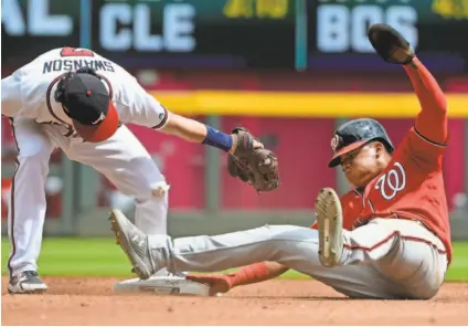  ?? JOHN AMIS/AP ?? The Nationals’ Juan Soto, avoiding a tag attempt by Dansby Swanson, became the youngest (19 years, 325 days old) with three steals in a game Sept. 15 against the Braves.