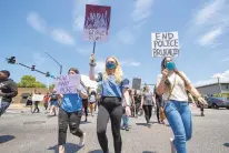  ??  ?? Protesters shout ‘I can’t breathe,’ ‘Black Lives Matter’ and ‘No justice, no peace,’ as they march on E. Virginia Beach Blvd. in Norfolk on Saturday.