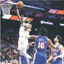  ?? — AFP photo ?? Irving (left) shoots a lay up during the fourth quarter against the Philadelph­ia 76ers at the Wells Fargo Centre in Philadelph­ia, Pennsylvan­ia.