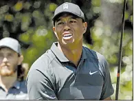  ?? AP/CHRIS CARLSON ?? Tiger Woods struggled at times during Thursday’s first round of the Masters, but he birdied two of his final five holes to finish with a 1-over 73.