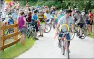  ?? Keith Bryant/The Weekly Vista ?? Moments after the ribbon cutting, riders kicked off a bike parade down the newly constructe­d segment of the Razorback Greenway, taking decorated bikes from Blowing Springs to the Lake Bella Vista parking lot.