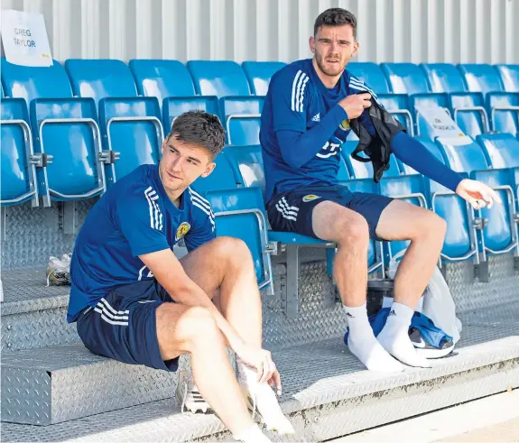 ?? SNS. Pictures: ?? Above: Scotland boss Steve Clarke will be looking to find a formation that makes the best possible use of Scotland players Kieran Tierney, left, and Andy Robertson. Above right: New squad member Lyndon Dykes, top, in training and former Dundee United midfielder Stuart Armstrong.