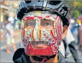  ??  ?? A protesters wearing an improvised protective gear looks on during a demonstrat­ion against the coup in Yangon.