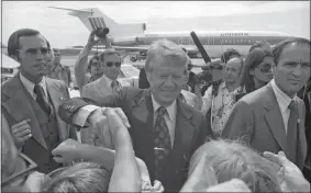  ?? ?? Left, presidenti­al candidate Jimmy Carter shakes hands on the campaign trail at what was then called Trumbull Airport in Groton on Sept. 7, 1976. He’s wearing a submarine tie clasp given to him by former Connecticu­t Gov. John N. Dempsey.