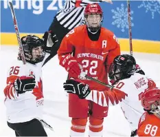  ?? JUNG YEON-JE/AFP/GETTY IMAGES ?? Emily Clark of Saskatoon, left, celebrates after scoring a third-period goal for Team Canada at the Winter Olympics.