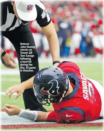  ?? AP ?? Referee John Hussey checks on Texans QB Tom Savage following a hard hit during the Dec. 10 game in Houston.
