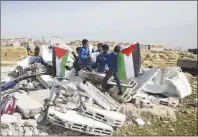  ?? AP PHOTO ?? Bedouin children stand on the rubble of two classrooms destroyed by the Israeli army in the village of Abu Nuwar, West Bank.