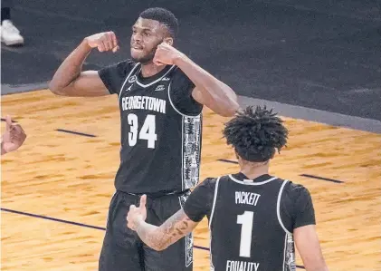  ?? MARYALTAFF­ER/AP ?? Georgetown center Qudus Wahab (34) and forward Jamorko Pickett celebrate after Wahab scored during the second half against Villanova in the quarterfin­als of the Big East Tournament on Thursday in NewYork. The Hoyas won 72-71.