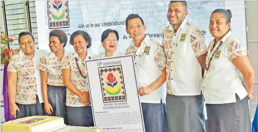  ?? Picture: JONA KONATACI ?? South Pacific Business Developmen­t Microfinan­ce office staff members with director Lorraine Seeto and general manager and director Elrico Munoz with the new logo after its launch yesterday.