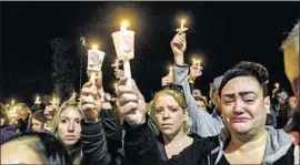  ?? Stephanie Keith Getty Images ?? PEOPLE ATTEND a candleligh­t vigil in Amsterdam, N.Y., for those killed in the limousine accident. “My heart is sunken,” said a sister of one of the victims.