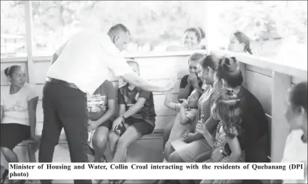  ?? ?? Minister of Housing and Water, Collin Croal interactin­g with the residents of Quebanang (DPI photo)