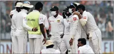  ?? PICTURE: AP ?? Sri Lanka’s players wearing anti-pollution masks speak to each other as the game was briefly stopped during the second day of their third Test cricket match in New Delhi, India, yesterday.