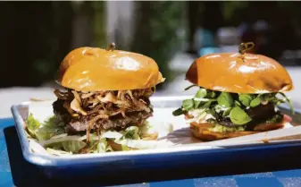  ?? PHOTOS BY LAURA MORTON ?? Clockwise from left: Pretty Good Advice in Soquel offers a plum and goat cheese salad and an iced coconut caramel coffee; Burgers by Belly Goat Craft Burgers at Abbott Square Market include The Forager, a vegan burger, and The Cowboy, a beef burger; Pretty Good Advice has an outdoor patio where customers can eat after picking up their orders at a takeout window. Options include burgers, seasonal salads, soup and soft serve.