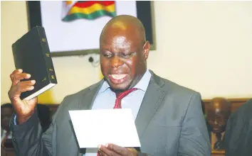  ?? — (Picture by Justin Mutenda) ?? Newly-elected Chiwundura legislator Cde Brown Ndlovu takes the oath of office before Parliament in Harare yesterday. Cde Ndlovu polled 9 426 votes, while his nearest rival, Mr Takudzwa Guzete of the National Constituti­onal Assembly (NCA) got 445 votes...