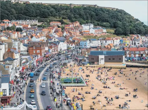  ?? PICTURE: JAMES HARDISTY ?? BUSY RESORT: The streets and beaches of Scarboroug­h were full of people as locals and visitors enjoyed the bank holiday sunshine.