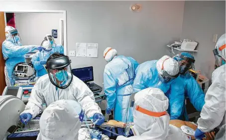  ?? Godofredo A. Vásquez / Staff file photo ?? Doctors and nurses work on a patient at the COVID-19 Intensive Care Unit at Houston’s United Memorial Medical Center last month. The U.S. has the highest COVID-19 death toll of any nation: nearly 400,000, a New York Times database shows.