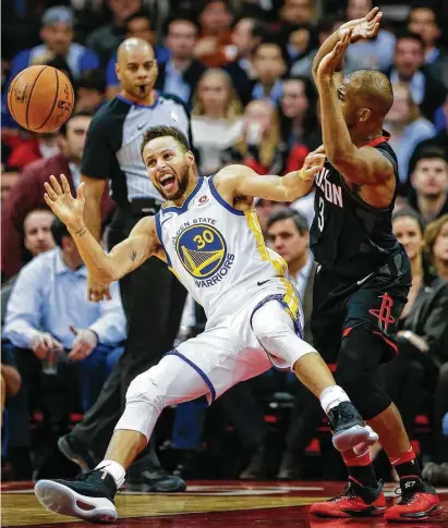  ?? Brett Coomer / Houston Chronicle ?? Warriors guard Stephen Curry, left, stumbles backward when he is fouled by the Rockets’ Chris Paul during the first half at Toyota Center on Thursday night. Curry scored 29 points, and Paul had 28.