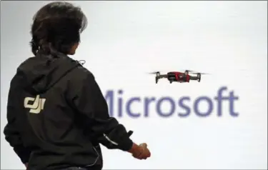  ?? ELAINE THOMPSON — THE ASSOCIATED PRESS ?? A DJI employee demonstrat­es use of a tiny drone during the keynote address at Build, Microsoft’s annual conference for software developers Monday in Seattle.