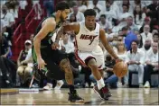  ?? LYNNE SLADKY — THE ASSOCIATED PRESS ?? Heat guard Kyle Lowry (7) dribbles the ball around Celtics forward Jayson Tatum (0) during the first half of Game 5 of the Eastern Conference finals Wednesday in Miami.