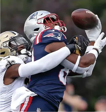  ?? ?? ALMOST HAD IT: Patriots tight end Jonnu Smith misses a catch as Malcolm Jenkins of the New Orleans Saints wraps his arms around him at Gillette Stadium on Sept. 26 in Foxboro.