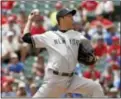  ?? BRANDON WADE—THE ASSOCIATED PRESS ?? New York Yankees starting pitcher Hiroki Kuroda, of Japan, throws in the first inning of a baseball game against the Texas Rangers on Thursday.