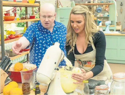  ??  ?? In the mix: Nadine Coyle during one of the challenges watched by host Matt Lucas in the Bake Off tent
