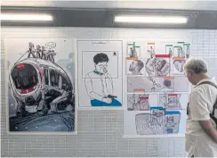  ??  ?? A drawing affixed to a wall in Hong Kong depicts Carrie Lam, chief executive of the territory, wiping away tears while simultaneo­usly aiming a gun resting on her lap.