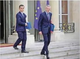  ??  ?? PARIS: This file photo taken on July 12, 2017 shows French Economy Minister Bruno Le Maire (right) and Public Action and Accounts Minister Gerald Darmanin (left) leaving the Elysee Palace in Paris after a weekly cabinet meeting. — AFP
