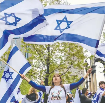  ?? DAVE SIDAWAY ?? Thousands of supporters of Israel attended a rally at Montreal's Place du Canada on Tuesday to celebrate the 76th anniversar­y of the founding of Israel. Across the street, demonstrat­ors carrying Palestinia­n flags formed a counter-protest, but both sides remained peaceful throughout.