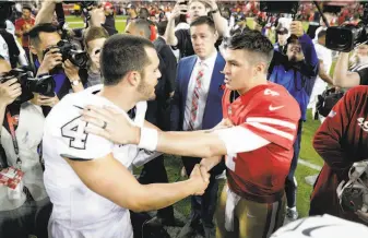  ?? Carlos Avila Gonzalez / The Chronicle ?? Raiders quarterbac­k Derek Carr (left) shakes hands with 49ers quarterbac­k Nick Mullens on Thursday night after Mullens led his team to a 34-3 win over Oakland at Levi's Stadium.