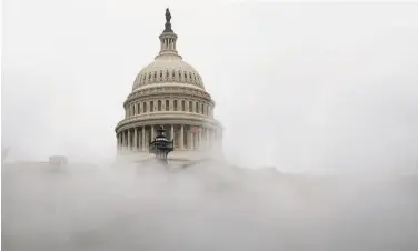  ?? Andrew Caballero- Reynolds / AFP / Getty Images ?? Congress approved stimulus payments, with some changes from the first round earlier this year.