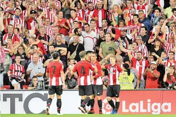  ?? - AFP Photo ?? Basques united: Athletic Bilbao players celebrate a goal against Real Madrid this season.