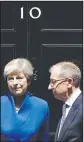  ?? AP/MATT DUNHAM ?? British Prime Minister Theresa May and her husband Philip stand on the doorstep of 10 Downing St. in London.