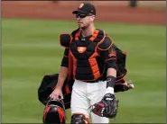  ?? (AP/Jae C. Hong) ?? San Francisco Giants catcher Buster Posey returns to the field this season after opting out of playing last year because of coronaviru­s concerns. “Watching the games on TV last year and seeing just cardboard fans in the stands, it was definitely nice to see some live humans out there,” Posey said.