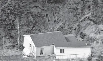  ?? DIANE CROCKER • THE TELEGRAM ?? A huge crater was left in the hillside above Main Road in Lark Harbour when a landslide swept the ground to the yard below, knocking the Childs’ house off its foundation on March 29, 2024.