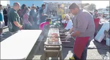  ?? HALAL FEST ?? A vendor grills halal meat skewers as customers line up at the Halal Fest in Fremont.